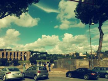 Parking lot against cloudy sky