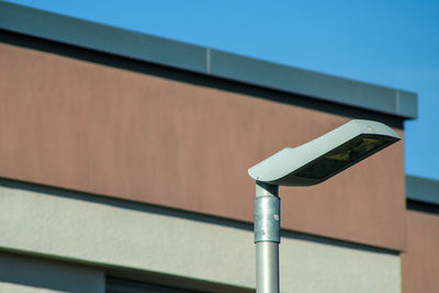 Low angle view of metal railing against building