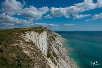 Scenic view of sea against cloudy sky