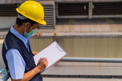 Side view of man working at construction site