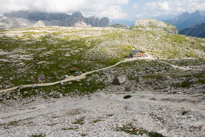 Scenic view of green landscape against mountain range