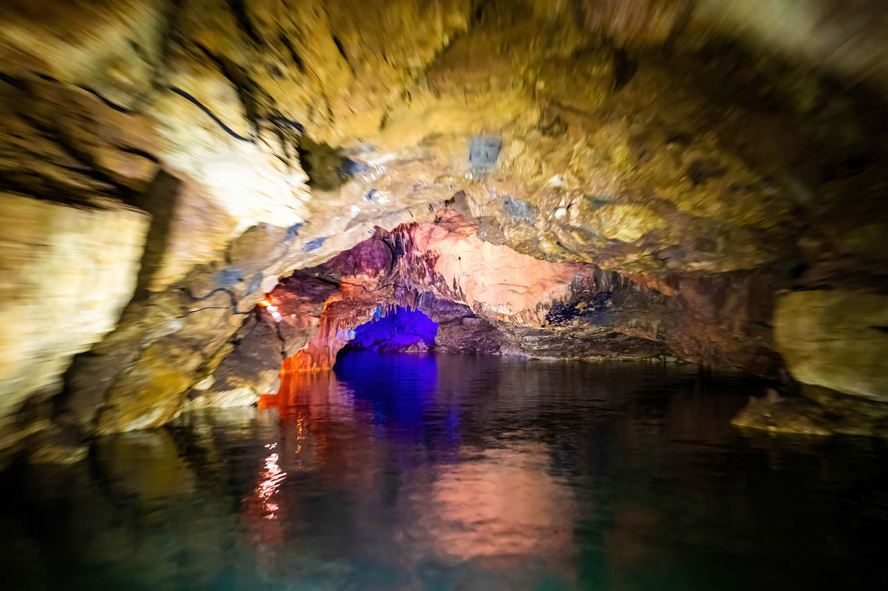 LOW ANGLE VIEW OF CAVE IN WATER