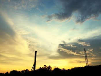 Low angle view of silhouette trees against sky during sunset