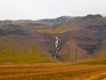 Scenic view of landscape and mountains against sky