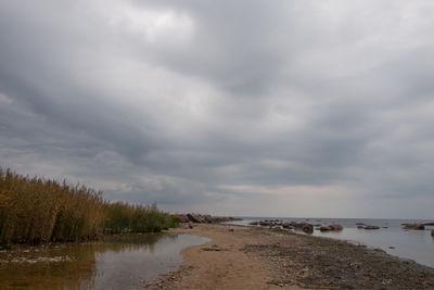 Scenic view of sea against storm clouds