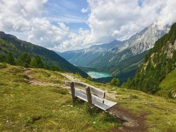 Scenic view of mountain range against cloudy sky