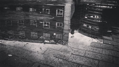 High angle view of buildings seen through wet window