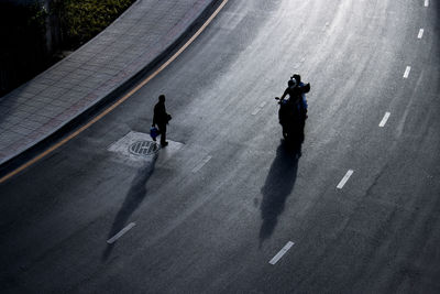 High angle view of people walking on road