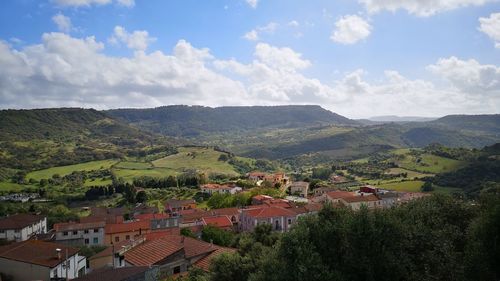 Aerial view of townscape against sky and mountainridge