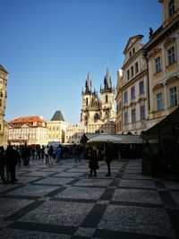 People in town square against clear sky