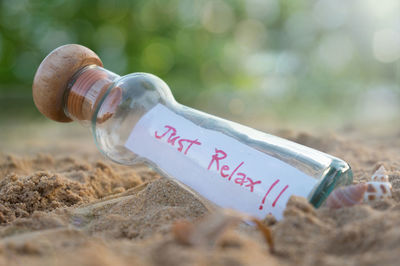 Close-up of text on glass bottle