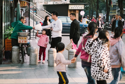 Group of people in front of buildings