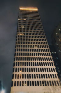 Low angle view of skyscrapers lit up at night