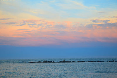 Scenic view of sea against sky at sunset