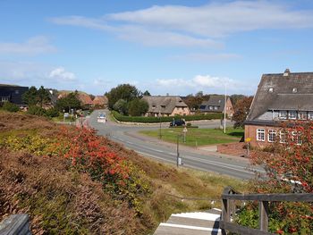 High angle view of road by buildings against sky