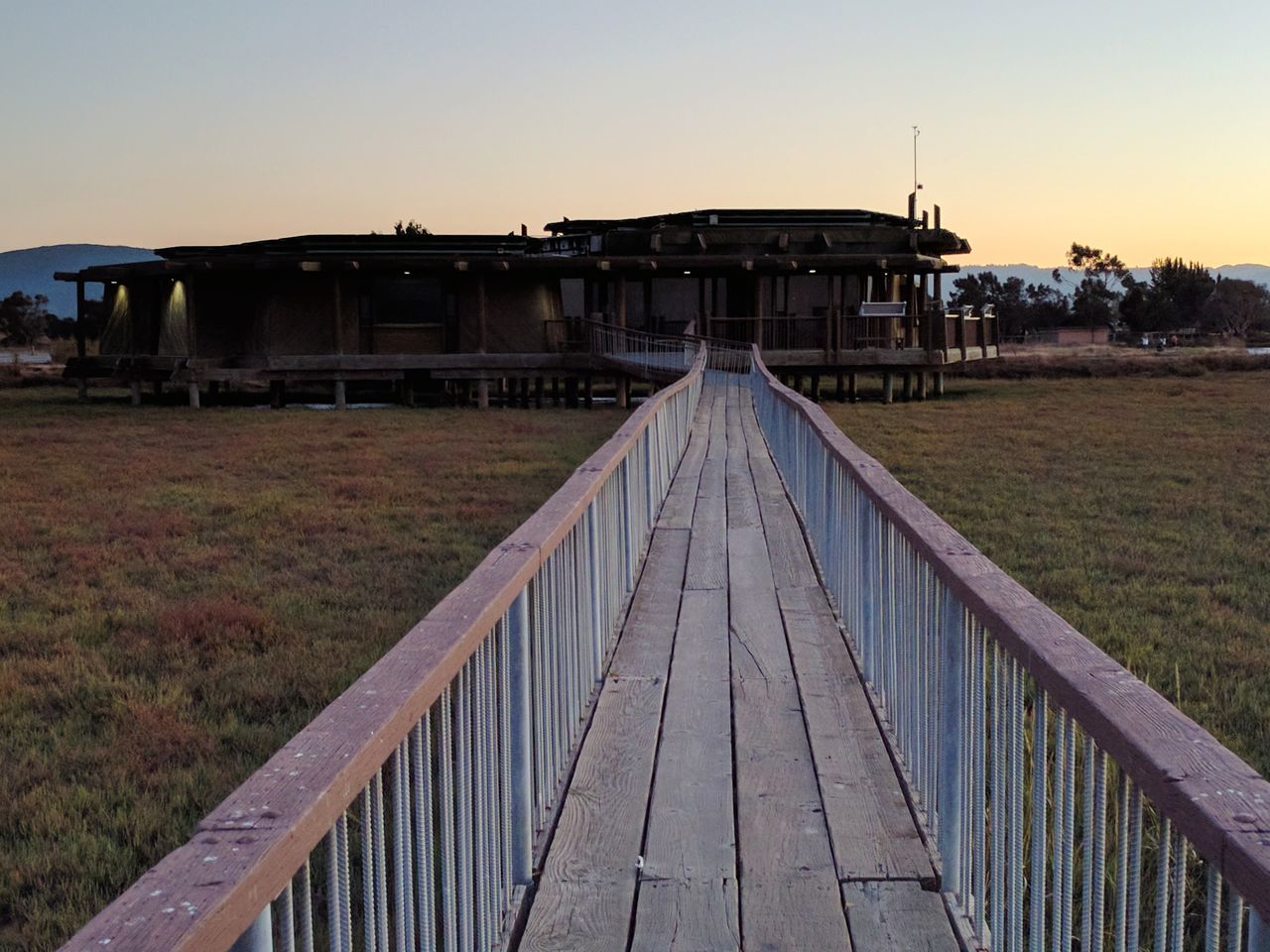 architecture, built structure, building exterior, clear sky, house, bridge - man made structure, railing, walkway, the way forward, sky, scenics, outdoors, narrow, footbridge, nature, footpath, boardwalk, leading, no people