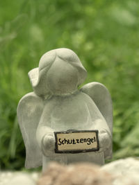 Close-up of angel statue in cemetery