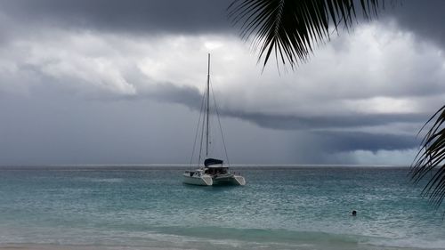 Sailboat in sea against sky