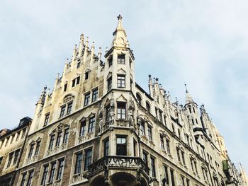 Low angle view of building against cloudy sky