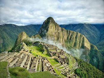 Scenic view of mountains against cloudy sky