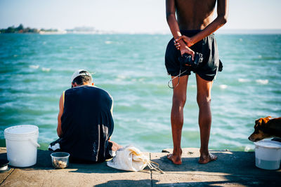 Rear view of men on beach