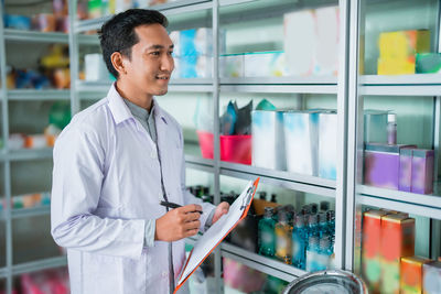 Portrait of young man standing in store