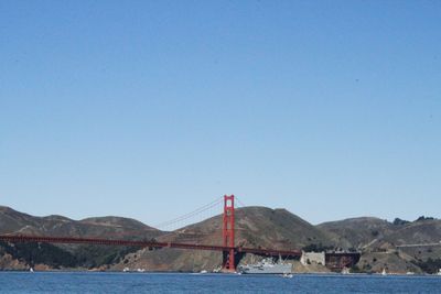 View of sailboat in sea against clear blue sky