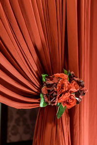 Close-up of red flower on curtain