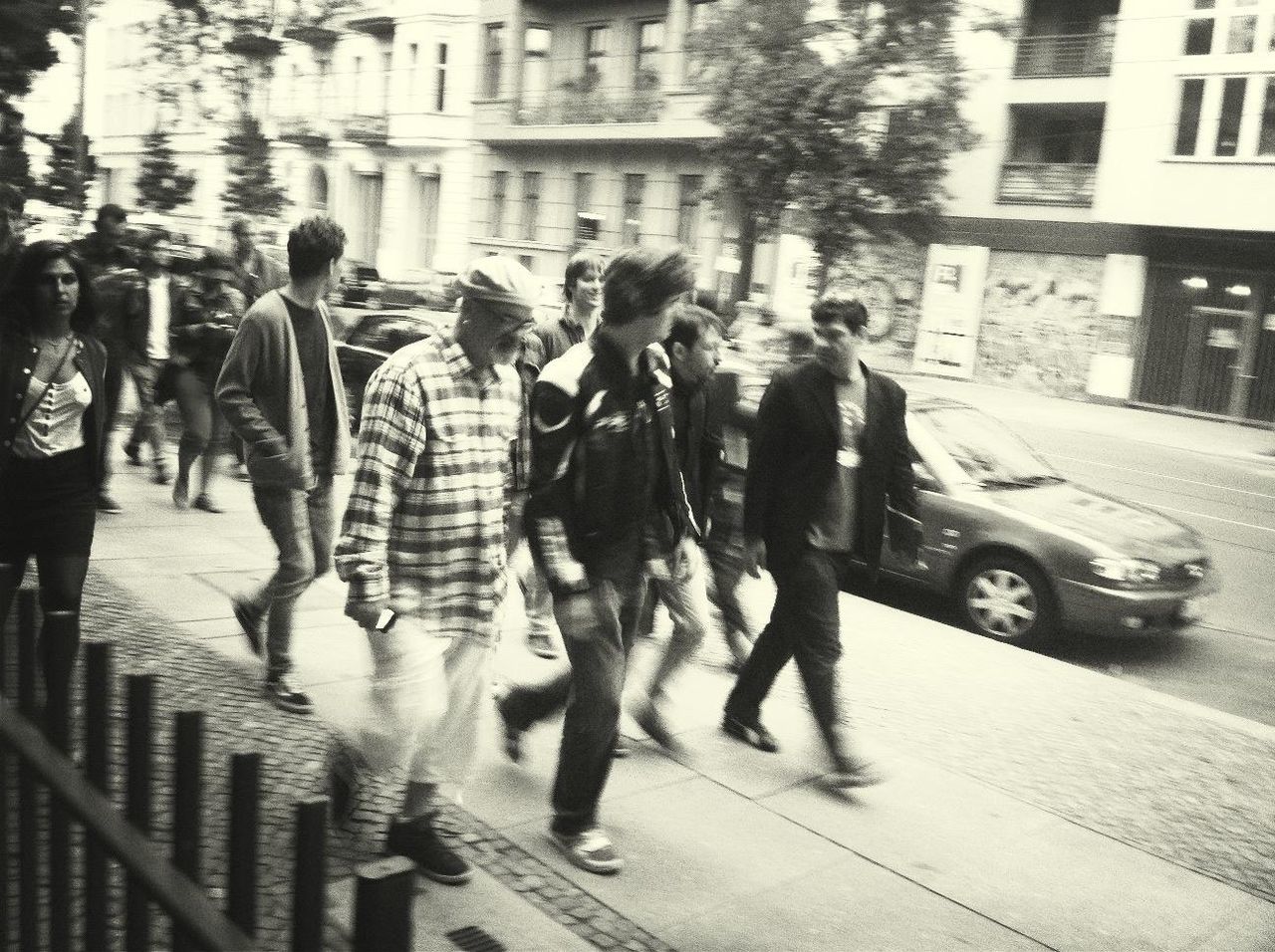 building exterior, street, walking, architecture, men, city, person, built structure, lifestyles, city life, large group of people, transportation, city street, road, leisure activity, mode of transport, on the move, land vehicle, full length