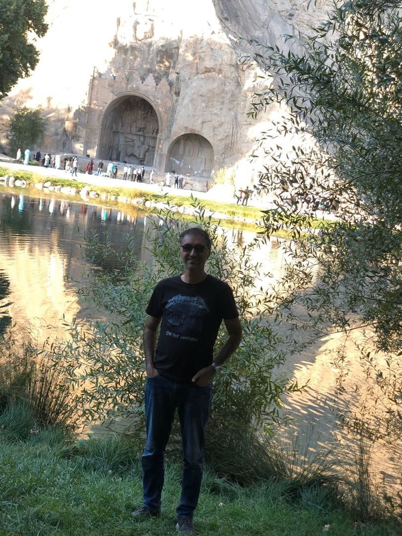 FULL LENGTH OF YOUNG MAN STANDING AGAINST PLANTS IN WATER