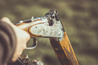 Cropped image of man holding shotgun