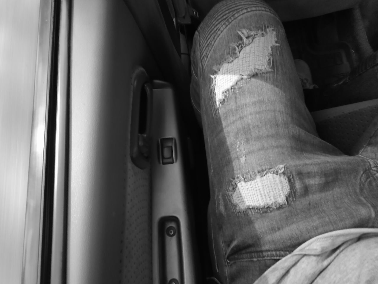 vehicle interior, real people, human body part, lifestyles, indoors, human leg, one person, car interior, close-up, men, land vehicle, day, people