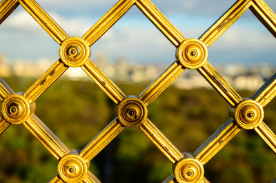 Close-up of metal structure against sky