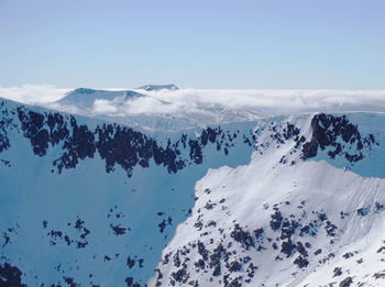 Scenic view of snow covered mountains against sky