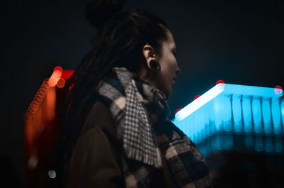 Low angle view of woman against black background