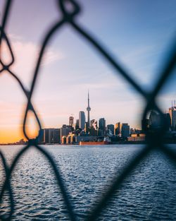 Cityscape seen through chainlink fence