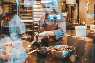 Midsection of woman working at store