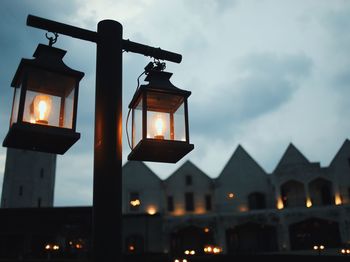 Low angle view of illuminated building against sky during sunset