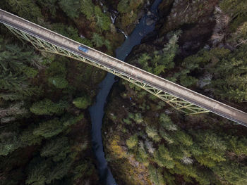 High angle view of bridge over road by trees