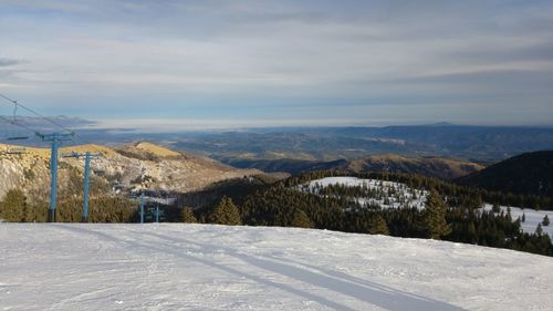 Scenic view of mountains against sky during winter