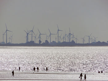 People on beach against sky