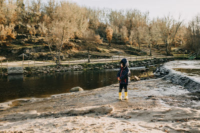 Rear view of woman walking on beach