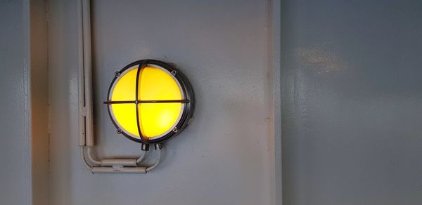 Close-up of yellow light on wall