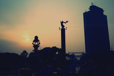 Silhouette built structure against sky during sunset