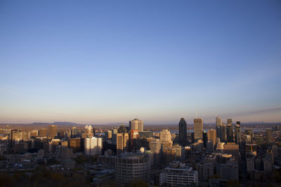 Modern buildings in city against clear sky