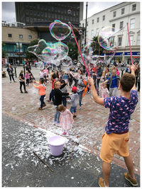 People playing on street in city