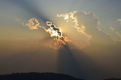 Sunlight streaming through clouds during sunset
