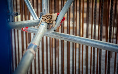 Low angle view of bamboo tied up on metal railing