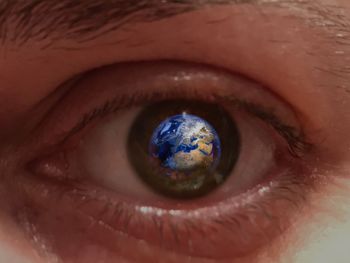 Digital composite image of planet earth reflection in eye