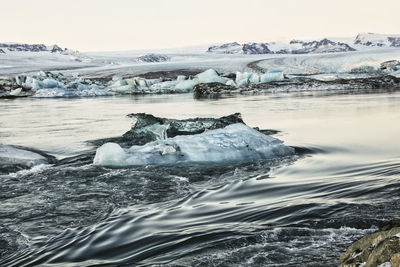 View of ice in lake against sky